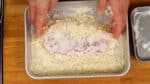 Cover the pork loin with breadcrumbs and press firmly to attach them together.
