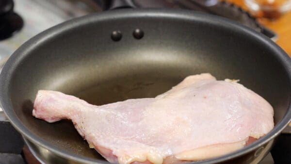 Once it's heated, place the marinated chicken with the skin side up.
