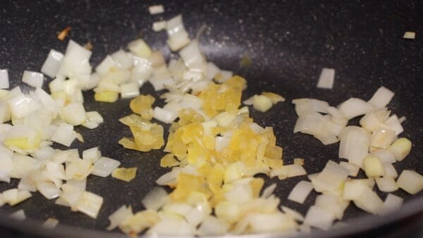 Add the finely chopped garlic and continue to stir-fry.