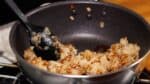 Gather the rice to one side. Add the soy sauce directly to the pan and toss to coat evenly.